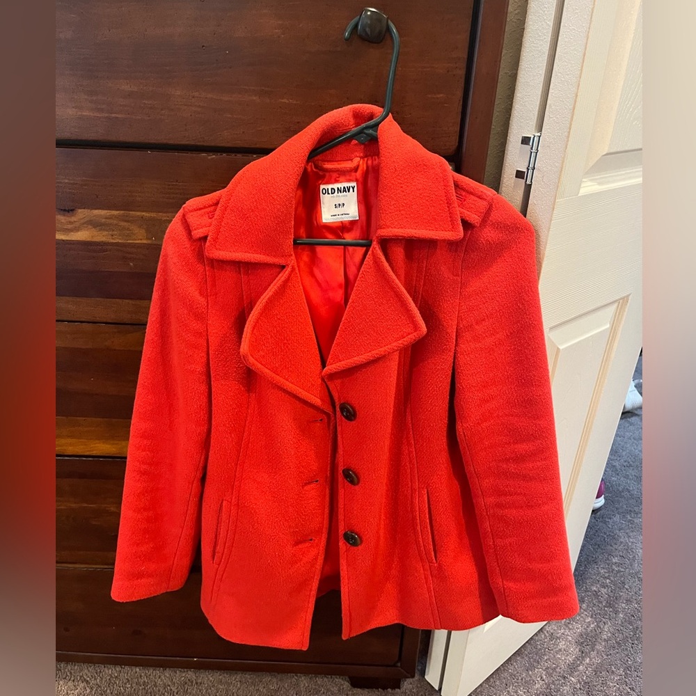 Orange trench coat. Mid length.